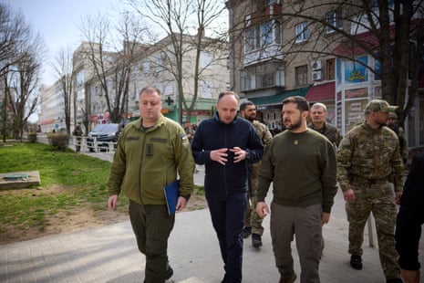 Ukraine’s president Volodymyr Zelenskiy walks along a street in Kherson region.