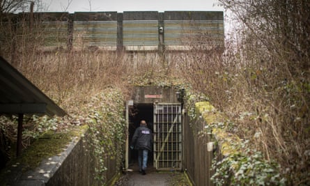 A police officer enters the bunker.