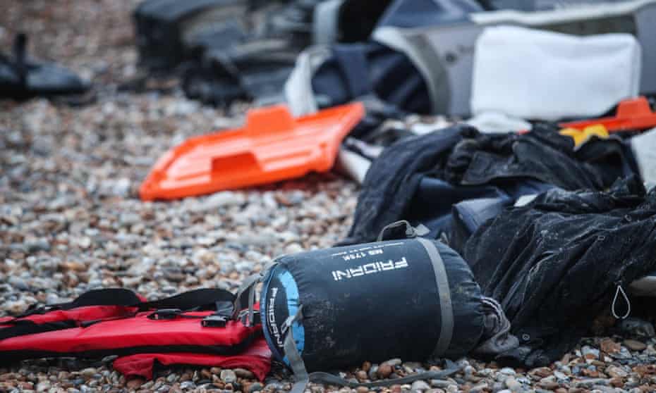 Remains of an inflatable boat and personal belongings left on the beach near Wimereux, France.