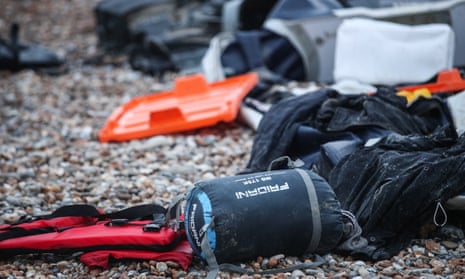 Remains of an inflatable boat and personal belongings left on the beach near Wimereux, France.