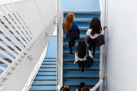 Schoolgirls walking up a stairwell