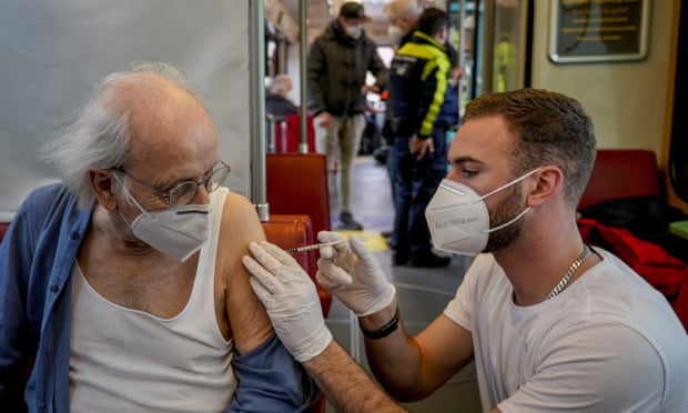 An 85-year-old man receiving a booster vaccination in central Frankfurt