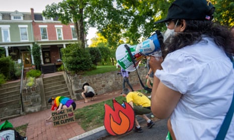 Protesters visit homes of senators they consider most responsible for a reduction in climate change regulations, on 30 June 2022 in Washington DC. 