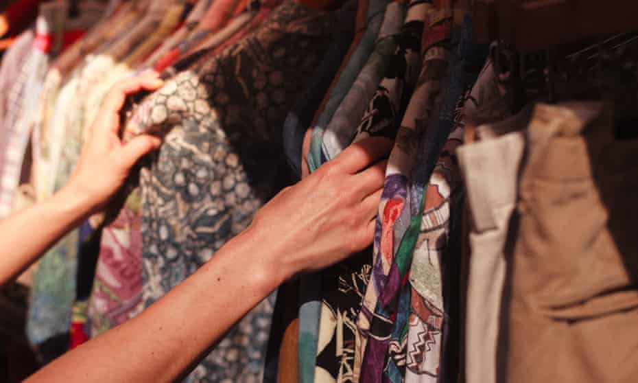 Woman browsing a rail of clothes