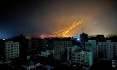 Smoke and flames rise during Israeli strikes, in Gaza City.