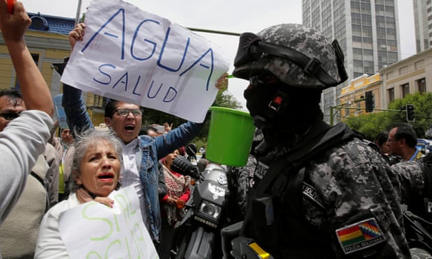 Demonstrators holding buckets protest over the ongoing drought in the centre of La Paz, Bolivia.