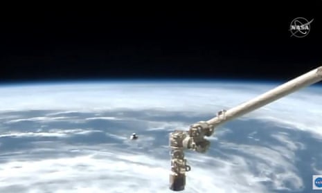 Nasa TV video grab shows the SpaceX Crew Dragon as it approaches the International Space Station with Earth visible in the distance 