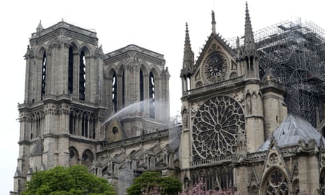 Firefighters work at Notre Dame Cathedral after a massive fire devastated large parts of the Gothic church in Paris.