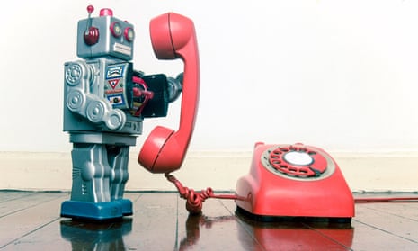 big silver robot toy on the phone standing on an old wooden floor