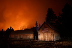 South Lake Tahoe, California, USThe Caldor fire burns in the hills above homes near South Lake Tahoe.