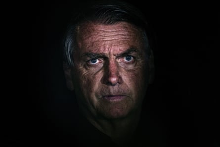 An older man’s face surrounded by shadows