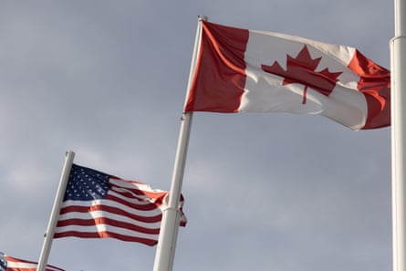 The American and Canadian flags fly at the midway point on the Gordie Howe International Bridge, that connects Windsor, Ontario, and Detroit, Michigan
