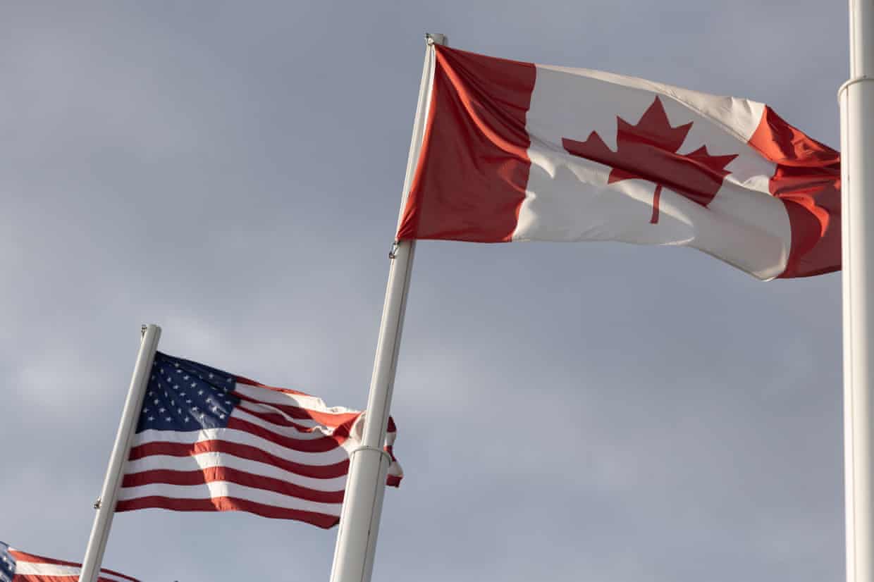 The American and Canadian flags fly at the midway point on the Gordie Howe International Bridge, that connects Windsor, Ontario, and Detroit, Michigan