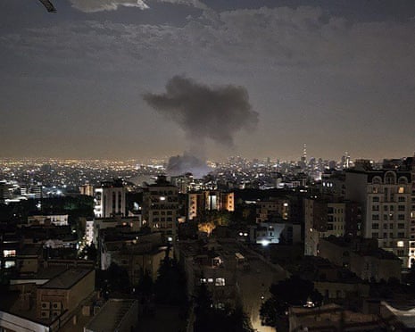 Smoke billows after a strike in Tehran in the early morning