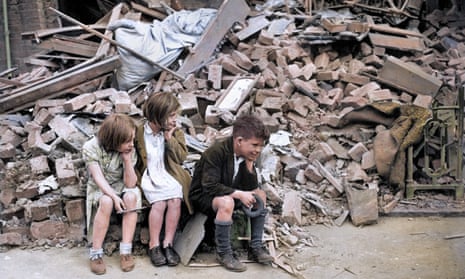 Three children sit by the rubble that had been their home after an overnight German bombardment destroyed the building in East London.