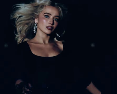 Sabrina Carpenter wearing a dark top