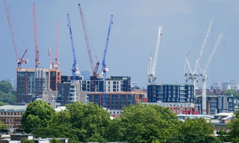 Construction cranes over a building complex in London