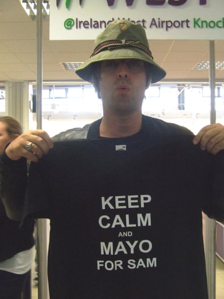 Liam Gallagher holding a T-shirt with the words ‘Keep calm and Mayo for Sam’
