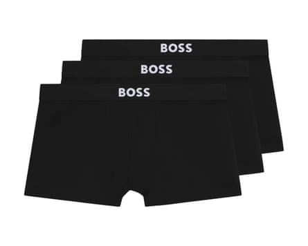 Three pairs of black stretch cotton trunks with a white Boss logo on the waistband