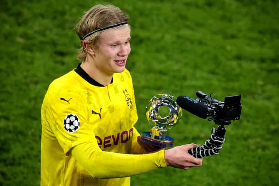Erling Braut Haaland poses with the player of the match trophy.