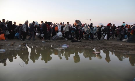Displaced Palestinians arrive in the northern Gaza Strip following Israel's decision to allow thousands of them to go back for the first time since the early weeks of the war.