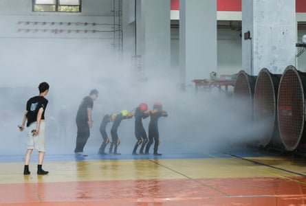 People participate in typhoon survival training in HangzhouParticipants walk through simulated typhoon-force wind and rain during a typhoon survival training session at the Lvxing Disaster Simulation Training Center in Hangzhou, Zhejiang province, China July 15, 2026. REUTERS/Go Nakamura