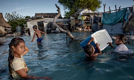 The people of Kiribati are under pressure to relocate due to sea-level rise. Flooding in the village of Eita on the Tarawa atoll is increasingly frequent.