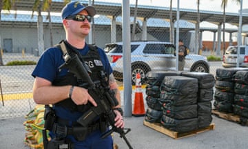 Law enforcement officer with gun at dockyard