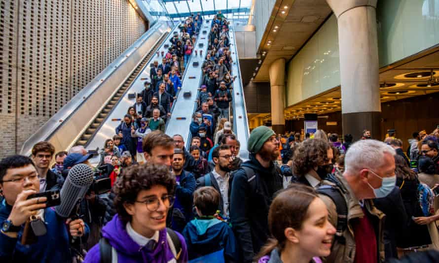 Crowds head down the escalator at Paddington as the Elizabeth line opened this morning.