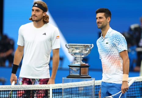 Stefanos Tsitsipas and Novak Djokovic stand at the net