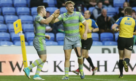 Newcastle’s Alex Tait, left, celebrates scoring one of his two tries against London Irish