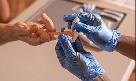 middle finger being pricked by a needle