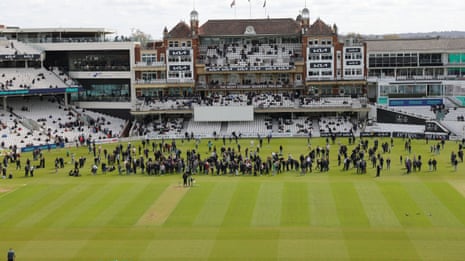 Spectators enjoying a walk on to the outfield at the Oval during lunch