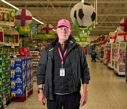 Allan Leighton in an Asda aisle with inflatable footballs in the background