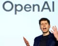 Altman speaking beneath an OpenAI logo