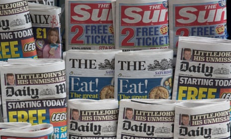 Tabloid papers at a newsstand