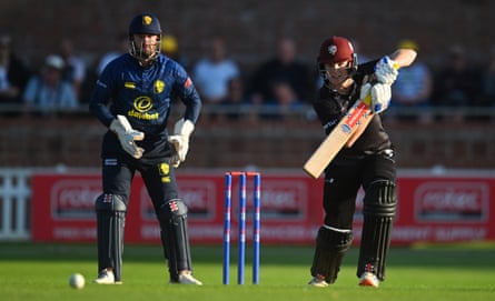Thomas Rew of Somerset plays a shot as Durham wicketkeeper Ollie Robinson looks on.