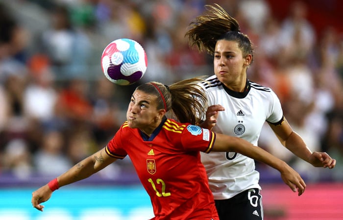 Spain’s Patri Guijarro heads the ball as Germany’s Lena Oberdorf looks on.