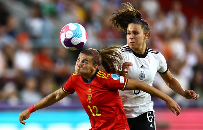 Spaniard Patri Guijarro heads the ball as German Lena Oberdorf looks on.
