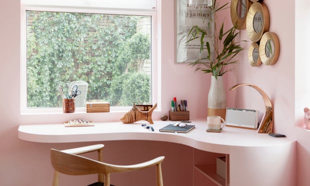 The blush-pink corner desk and walls