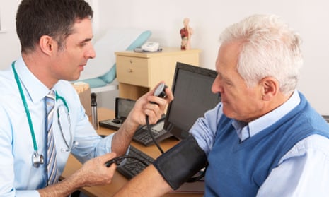 doctor taking senior man's blood pressure