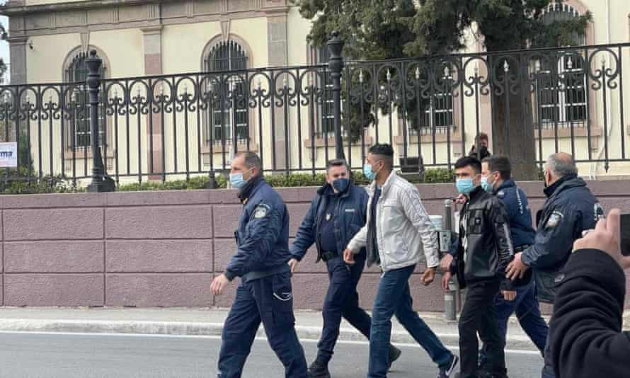 Greek court to hear appeals on life sentences for refugees accused of steering dinghies | Global development 2 Amir Zahiri and Akif Razuli being led under police escort into the appeals court in Lesbos.