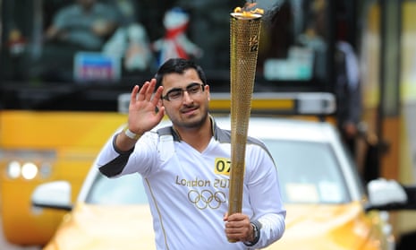 Gulwali Passarlay carries the Olympic flame between Burnley and Rawtenstall, June 2012