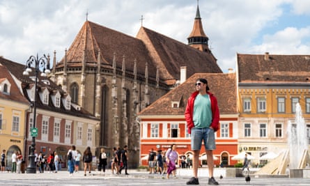 Ben Aitken in square with church Brasov, Romania.