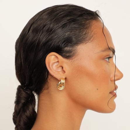 woman looking to the side wearing earrings