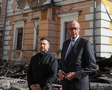 Ukraine's president Volodymyr Zelenskyy and German chancellor Friedrich Merz visit the site of an administrative building of Ukraine's Academy of Sciences on Sunday.