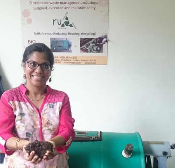Monisha Narke holds out a handful of shredded Tetra Pak cartons.