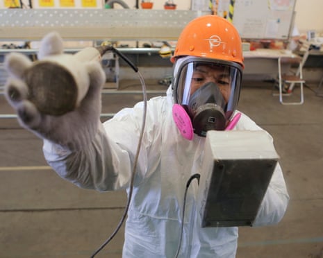 A radiation check on a bus during a visit by Japan’s PM Shinzo Abe to the Fukushima power plant in 2012.