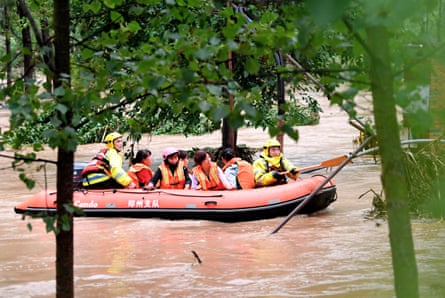 Rescuers transfer stranded villagers in Longtou.