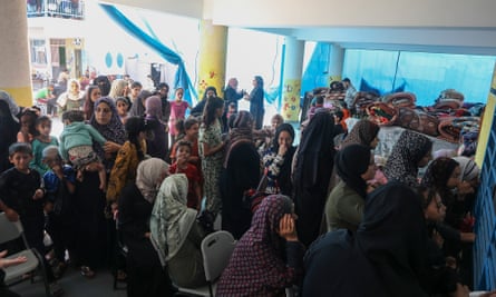 Crowds of women and children inside the school